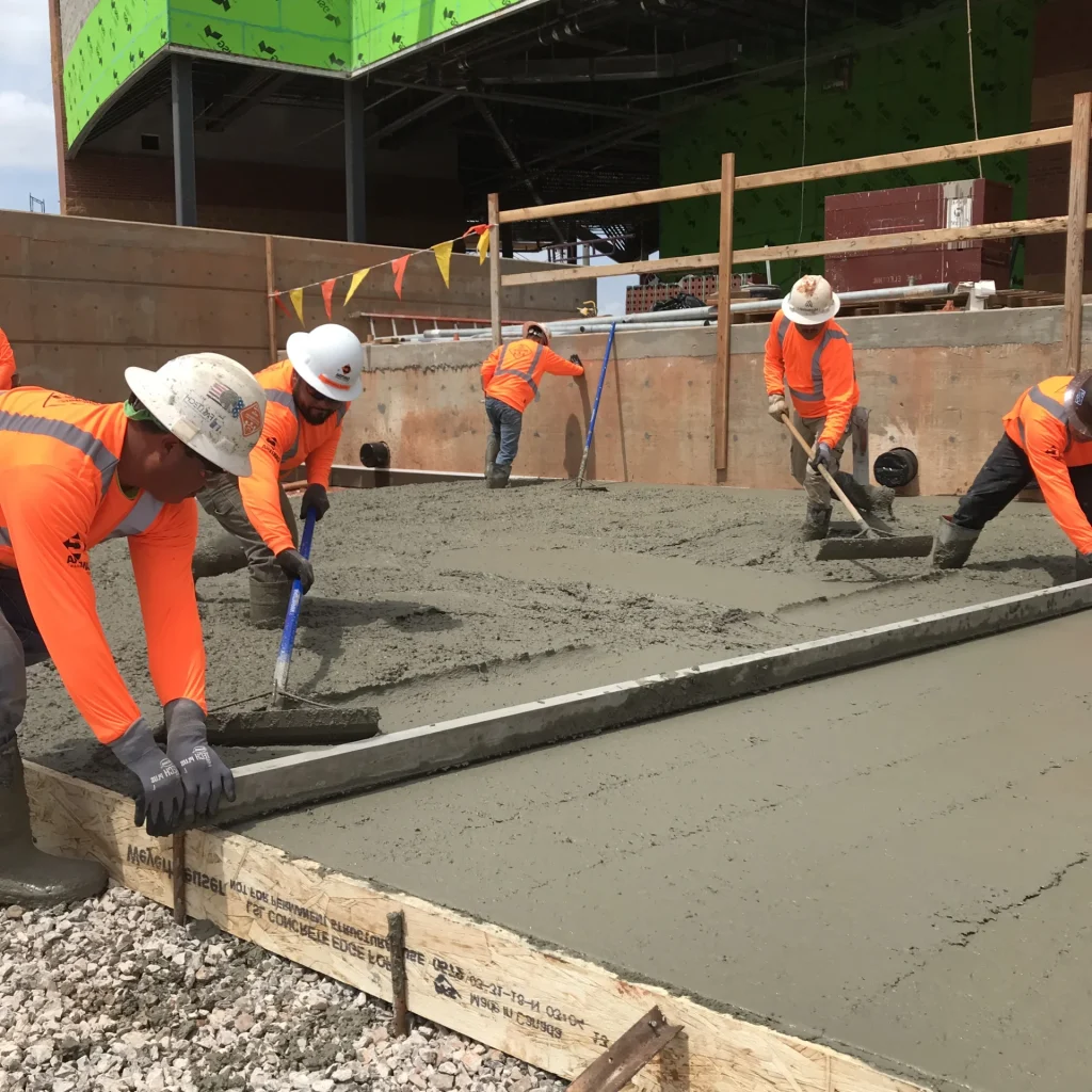 Team of concreters doing concrete slab installation